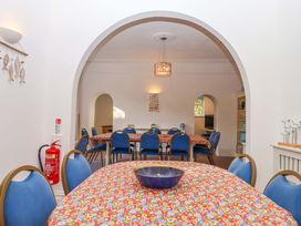 A dining room with a table and chairs at Babbacombe Hall in Babbacombe