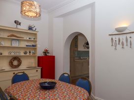 A dining room with a table and chairs at Babbacombe Hall Babbacombe
