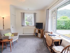 A living room with a sofa and television at Rock Cottage in Keswick