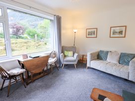A living room with a sofa and armchair at Rock Cottage in Keswick
