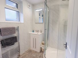 A bathroom featuring a shower, sink and towel rack at Rock Cottage in Keswick
