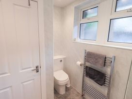 A bathroom with a toilet and towel radiator at Rock Cottage in Keswick