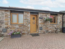 A facade with a door and window at Whitsand in Tideford