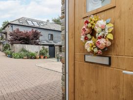 An entrance with a wreath on the door at Whitsand in Tideford