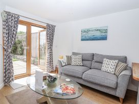 A living room with a sofa and coffee table at Whitsand in Tideford