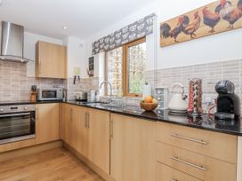A kitchen with a sink and appliances at Whitsand in Tideford