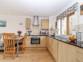 A kitchen with table and chairs at Whitsand in Tideford