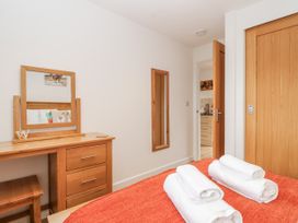 A bedroom with a dressing table and towels at Whitsand in Tideford