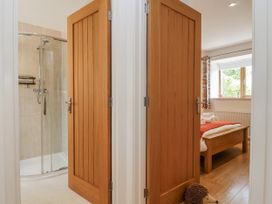 A bathroom with a shower and adjoining bedroom at Whitsand in Tideford