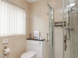 A bathroom with a toilet and shower at Whitsand in Tideford