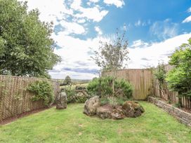A garden with trees and rocks at Whitsand in Tideford