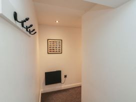 A hallway with coat hooks and a picture frame at Sir Nigel Gresley @ Engine Shed, Whitby