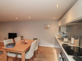 A kitchen with dining table and chairs at Sir Nigel Gresley @ Engine Shed Whitby