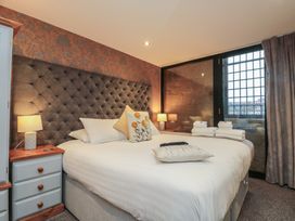 A bedroom with a bed and bedside table at Sir Nigel Gresley @ Engine Shed, Whitby
