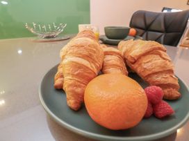 A plate with croissants, an orange and raspberries at Repton @ Engine Shed Whitby