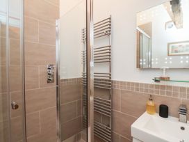 A bathroom featuring a shower, washbasin, and wall-mounted towel radiator at Repton @ Engine Shed in Whitby