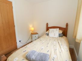 A bedroom with a bed and nightstand at New Peny in Llandrindod Wells