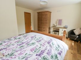 A bedroom with a bed and wardrobe at New Peny in Llandrindod Wells