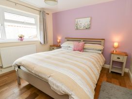 A bedroom with a bed and side tables at New Peny in Llandrindod Wells