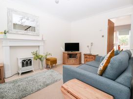 A living room with a sofa and television at 17 Fewster Way York