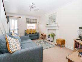 A living room with seating and a fireplace at 17 Fewster Way in York