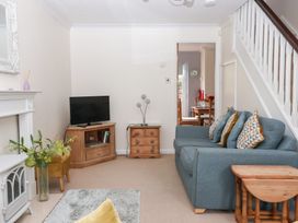 A living room with a sofa and television at 17 Fewster Way in York