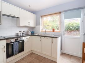 A kitchen with cabinets, sink, and oven at 17 Fewster Way, York
