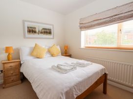 A bedroom featuring a bed with pillows and towels at 17 Fewster Way in York