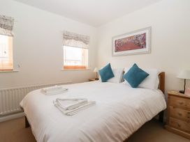 A bedroom with a bed and bedside lamps at 17 Fewster Way in York