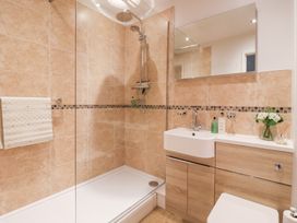 A bathroom with a shower, sink, and toilet at 17 Fewster Way in York
