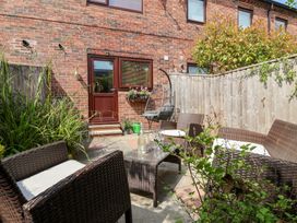 A garden with seating area and door at 17 Fewster Way, York
