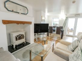 A living room with a fireplace and television at Preswylfa Apartment in Caernarfon