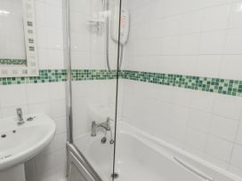 A bathroom with a shower and bathtub at Preswylfa Apartment Caernarfon