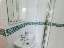 A bathroom with a sink and shower at Preswylfa Apartment in Caernarfon