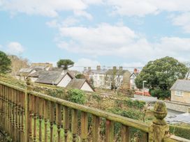 A view of houses and trees from a fence at Preswylfa Apartment Caernarfon
