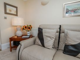 A living room with a sofa and decorative items at 5 Old Sail Loft in Whitby
