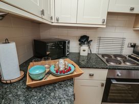 A kitchen with a food tray and utensils at 5 Old Sail Loft in Whitby