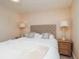 A bedroom with a bed and bedside tables at 5 Old Sail Loft in Whitby