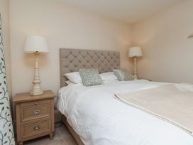 A bedroom with a bed and bedside table at 5 Old Sail Loft in Whitby