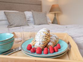 A tray with breakfast items in a bedroom at 5 Old Sail Loft Whitby
