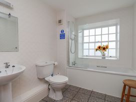 A bathroom with a bathtub and a toilet at 5 Old Sail Loft in Whitby
