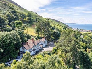 Tudor hall with hot tub, games room and sea views photo 1