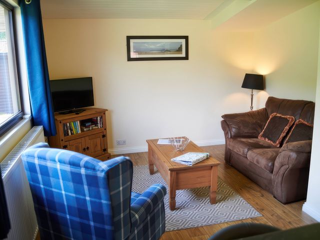 A living room with a sofa and coffee table at Foxglove Lodge in Saltburn-By-The-Sea