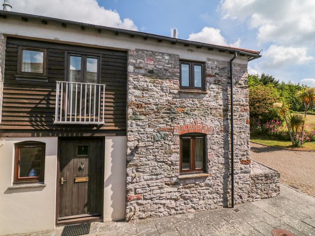 Exterior view of a stone and wood house with three windows and a black door with number 4 at The Tallet in Dittisham near Dartmouth