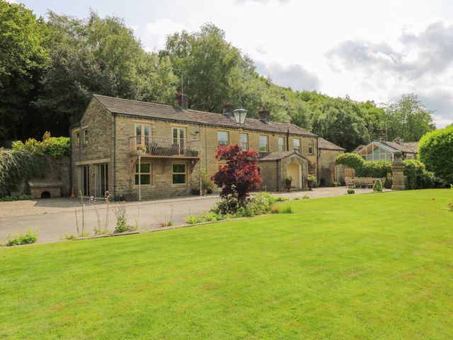 A house with a garden and pathway at Woodbottom Farm in Meltham