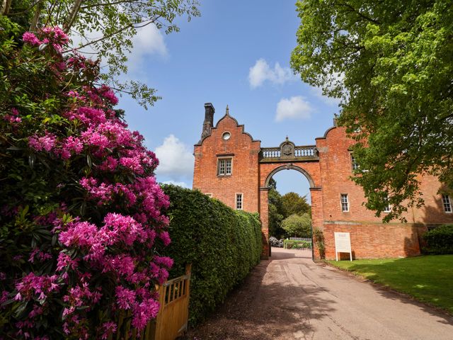 A gate with flowers and hedges at South Tower Cottage Capesthorne near Macclesfield
