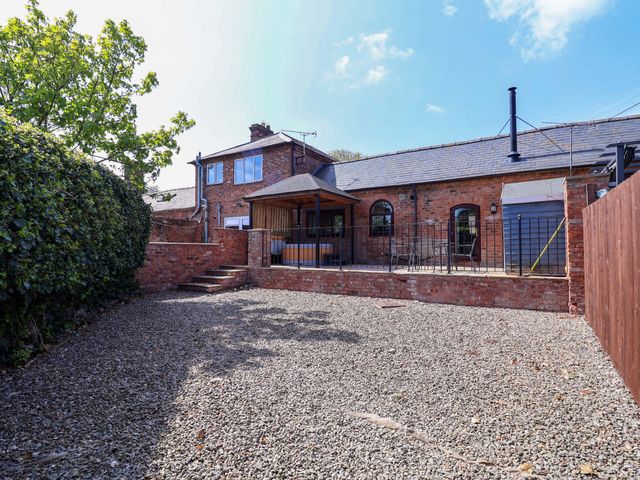 An outdoor area with a house and garden space at Clwyd Cottage in St Asaph