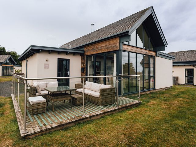 An outdoor area with seating and a table at Betony in Bamburgh