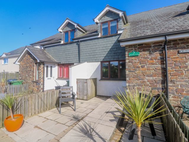 A house exterior with a paved area and a plant at Sunflower Cottage in St Issey