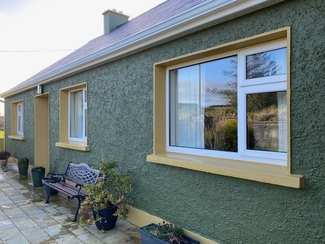 An outdoor area with a bench and windows at Sea View Hideaway in Lahinch, County Clare